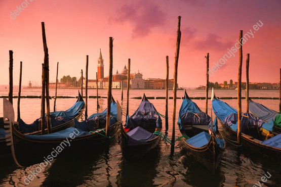 Wzornik fototapety przedstawia gondole w purpurowym świetle wschodu słońca, w Wenecja. Rodzaj takiej fototapety świetnie sprawdzi się w pokoju dziennym, salonie, sypialni, przedpokoju, jadalni, biurze.