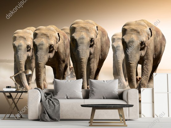 Wizualizacja fototapety przedstawia stado wędrujących słoni idących przez pustynię. Fototapeta w barwach brązu i szarości, do pokoju dziennego, dziecięcego, młodzieżowego, sypialni, salonu, przedpokoju, biura.